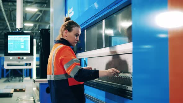 Female Worker Bending Aluminum Plate Using a Modern Machine