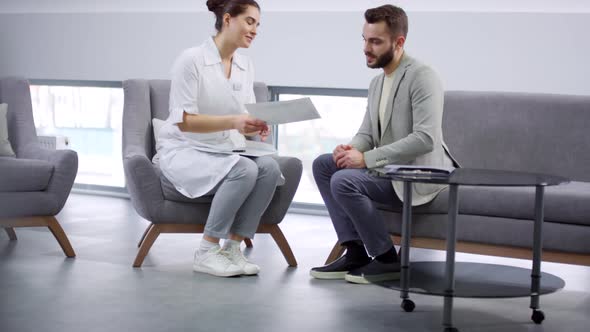 Female Orthodontist Discussing Treatment with Patient