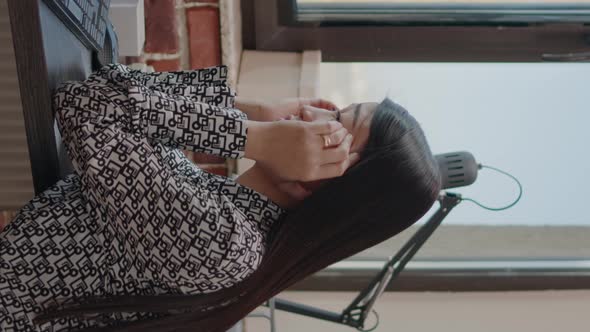 Vertical Video Business Woman Rubbing Temples Against Migraine at Work