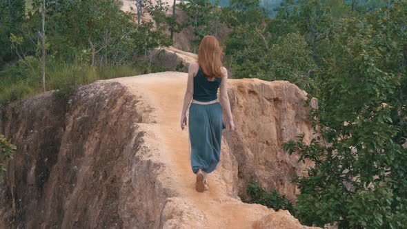 Girl Is Walking Along a Narrow Path in Pai Canyon in North Thailand