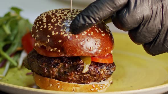 Slow motion of beef hamburger placed on a bun