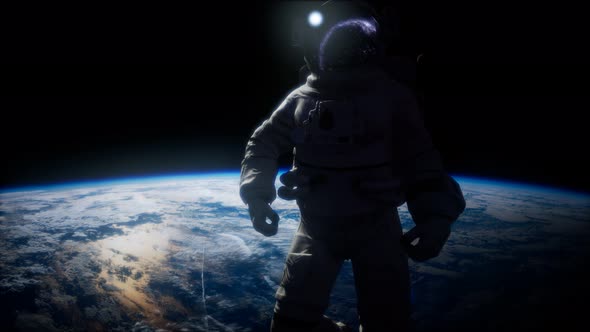 Astronaut in Outer Space Against the Backdrop of the Planet Earth