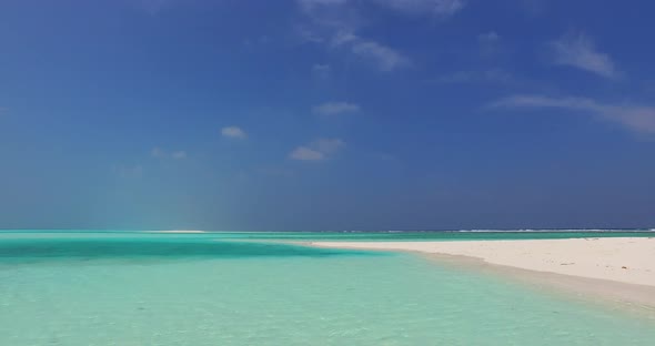 Luxury flying tourism shot of a paradise sunny white sand beach and aqua turquoise water background 