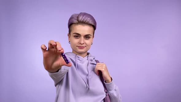 Confident Young Woman Showing Putting Tampon in Handbag All Purple
