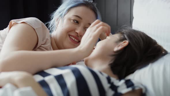 Video of lesbian couple lovingly talking and kissing in bed. Shot with RED helium camera in 8K