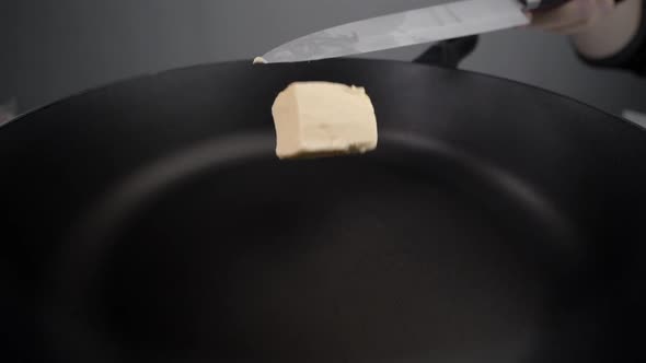 Chef Greases the Hot Pan with Butter, Melting Butter on the Pan, Butter on the End of the Knife