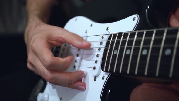 Close-up of an electric guitar plucking