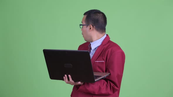 Happy Asian Businessman Using Laptop and Watching Adult Videos