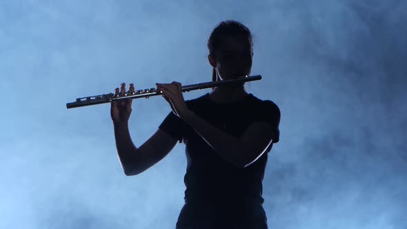 Professional Musician Female Playing on Flute. Smoky Isolated Studio, Silhouette