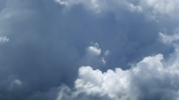 Fluffy cloud time lapse on a cloudy day 4k footage. alt