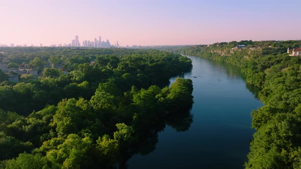 Aerial sweep of Redbud Isle nature trail in Austin, Texas during hazy summer sunrise in 2022 with 4k