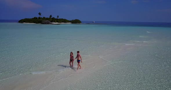 Fun boy and girl in love dating on vacation enjoy life on beach on white sand 4K background