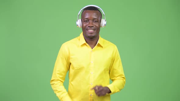 Young Happy African Businessman Listening To Music