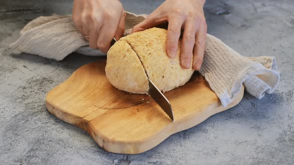 Married Man Cutting Fresh Homemade Yeast Free Bread. Husband Learning To Bake Bread At Home