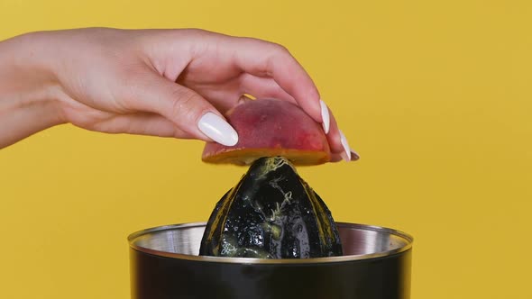 Juice From Fruit Using a Juicer. Fresh Juice with Pulp, Natural Drink. Close Up.