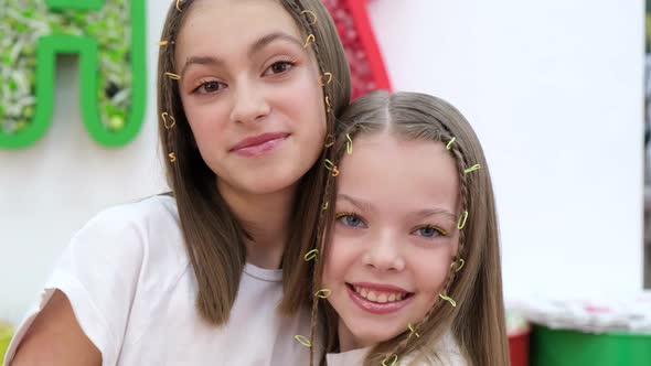 Portrait of Two Sisters Hugging and Laughing Happily