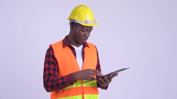 Young Happy African Man Construction Worker Holding Clipboard and Giving Thumbs Up