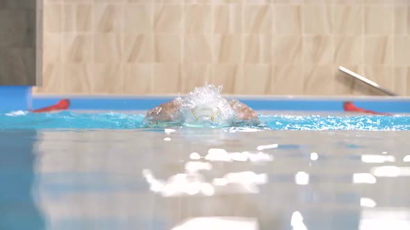 Swimming in Slow Motion, Swimmer in Action in Water Pool