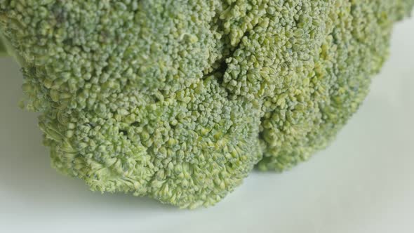 Tilting on organic  green broccoli close-up 4K 2160p 30fps UltraHD footage - Healthy Brassica olerac