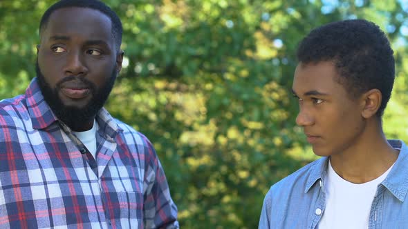 African-American Father Trying to Comfort Unhappy Son, Family Support, Trust