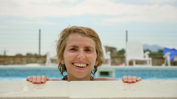 Girl Smiling at the Camera While in the Pool