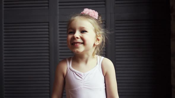 Portrait of a Cute Baby Girl Who Smiles at the Camera