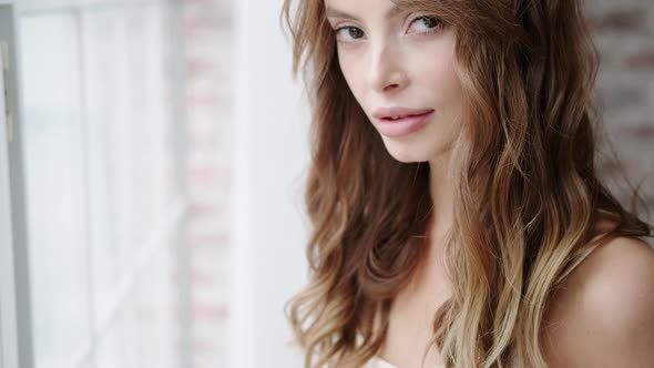 Morning Portrait of a Beautiful Young Woman Close-up. Pretty Woman Sexy Looking Into the Camera Lens