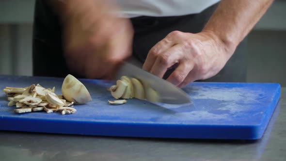 Close Up of a Chopping Mushrooms Chef on a Board