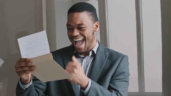 Smiling African Stylish Young Guy Black Man Businessman in Modern Office Room Alone Read Letter