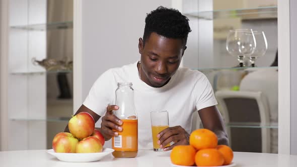 Slow Motion of African American Man Give Me a Juice in Kitchen