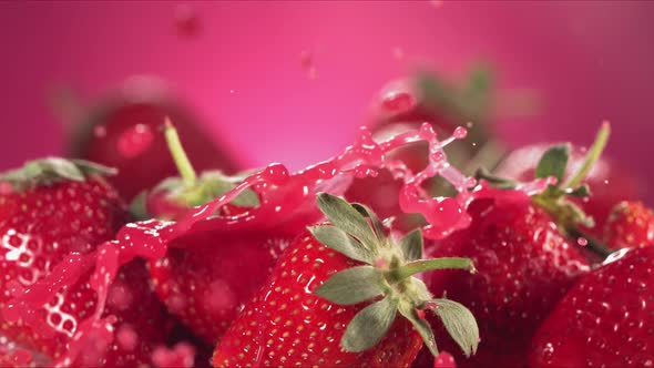 Slow Motion Shot of Strawberry Juice Splashing Through Strawberries