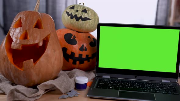 Modern Laptop with Green Screen Mockup with Chroma Key Stands on the Table in the Room