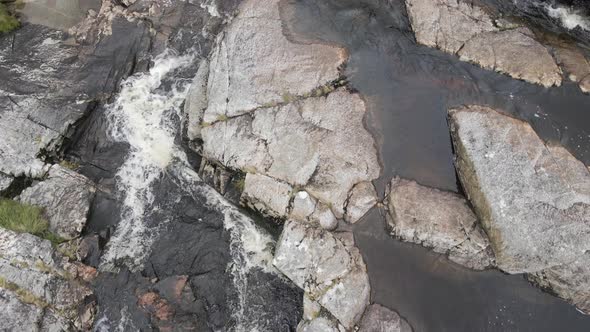 Brown Stream Water Flowing On The Rocky Landscape In The Wicklow Mountains, Ireland - aerial drone