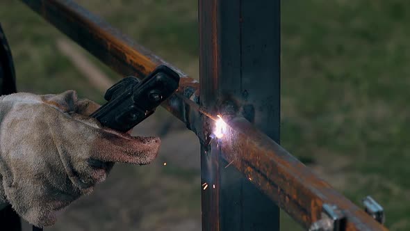 Close View Welder Builds Fence with Planks Using Modern Tool