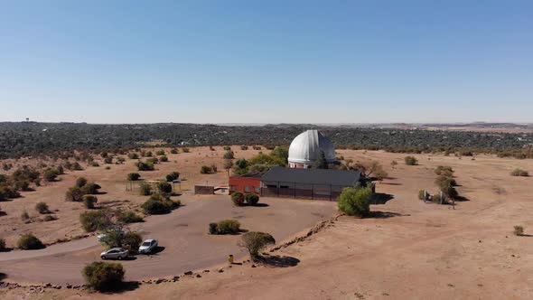 DRONE Drop Down Shot of a Observatory in a Nature Reserve on a Sunny Day