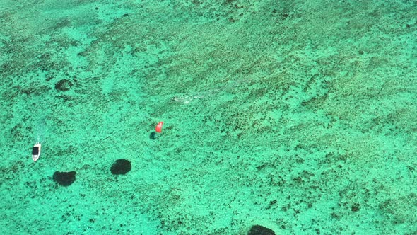 Aerial view of a kite surfer in the clear tropical water around Le Morne in Mauritius