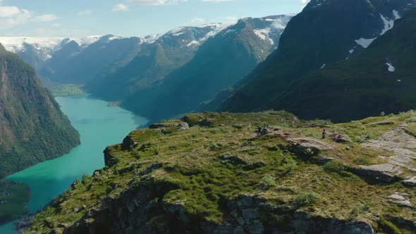 Tourists On Klovane Mountain Peak Overlooking Oldevatnet Lake In Vestland County, Norway. - aerial