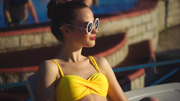 Attractive Woman in Yellow Swimsuit and Sunglasses Enjoying Recreation