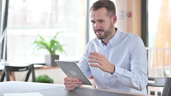 Success Young Man Celebrating on Tablet in Office