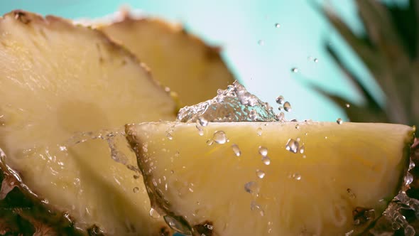 Slow Motion Shot of Pineapple and Water Splashing Through Pineapple Slices