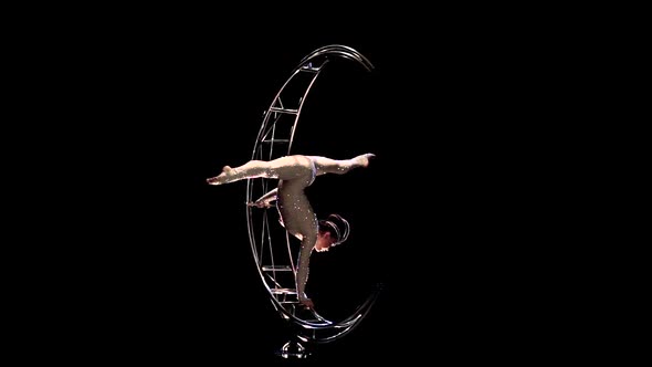 Gymnast Hangs Upside Down in a Twine on a Rotating Moon