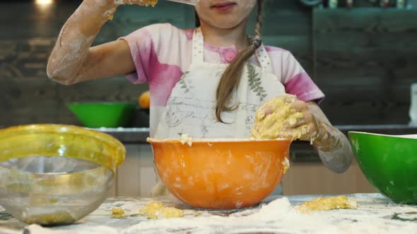 Girl adding cocoa powder into a bowl