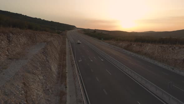 Aerial View of Car Speeding on Empty Highway