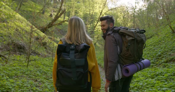 A Guy and a Girl Are Walking Through the Forest