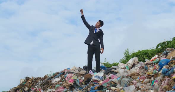 Businessman Cheerful On Garbage Pile