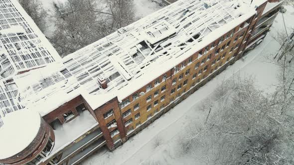 The Destroyed Roof Covered with Snow of a Highrise City Building