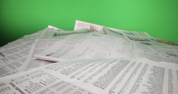 Macro Shot Through Newspapers in Front of Green Screen