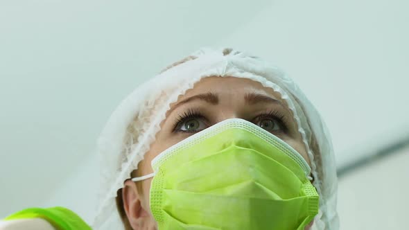 Assistant Surgeon Putting on Hat Prepares for Complex Operation, Professionalism