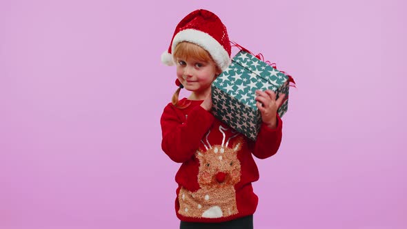 Funny Toddler Child Girl Wears New Year Sweater Received Present Interested in What Inside Gift Box