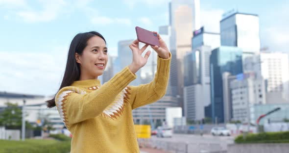 Woman search on cellphone in city